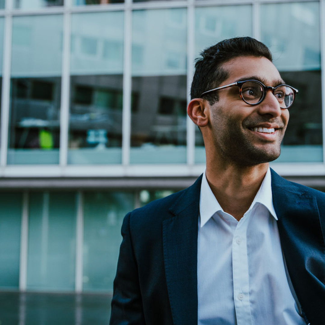 Person smiling with suit on